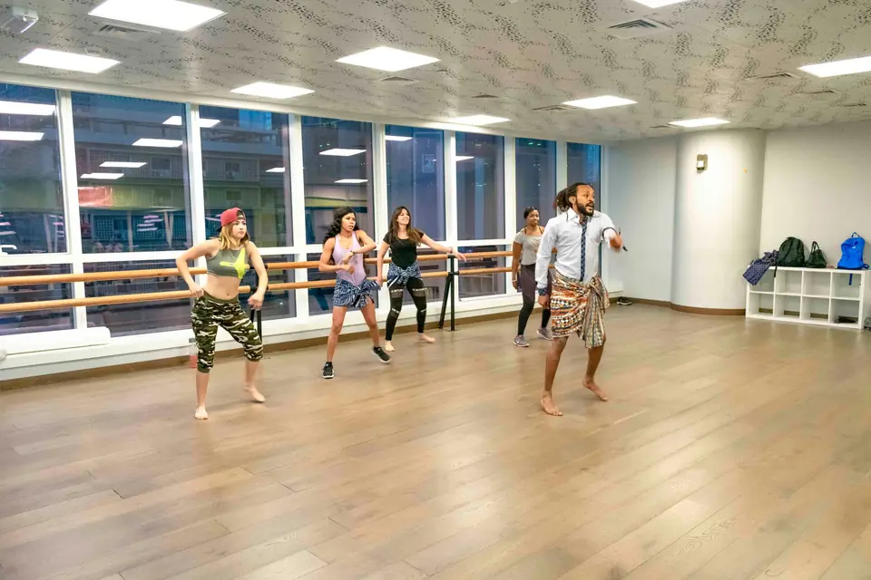 A group practising dance in a studio