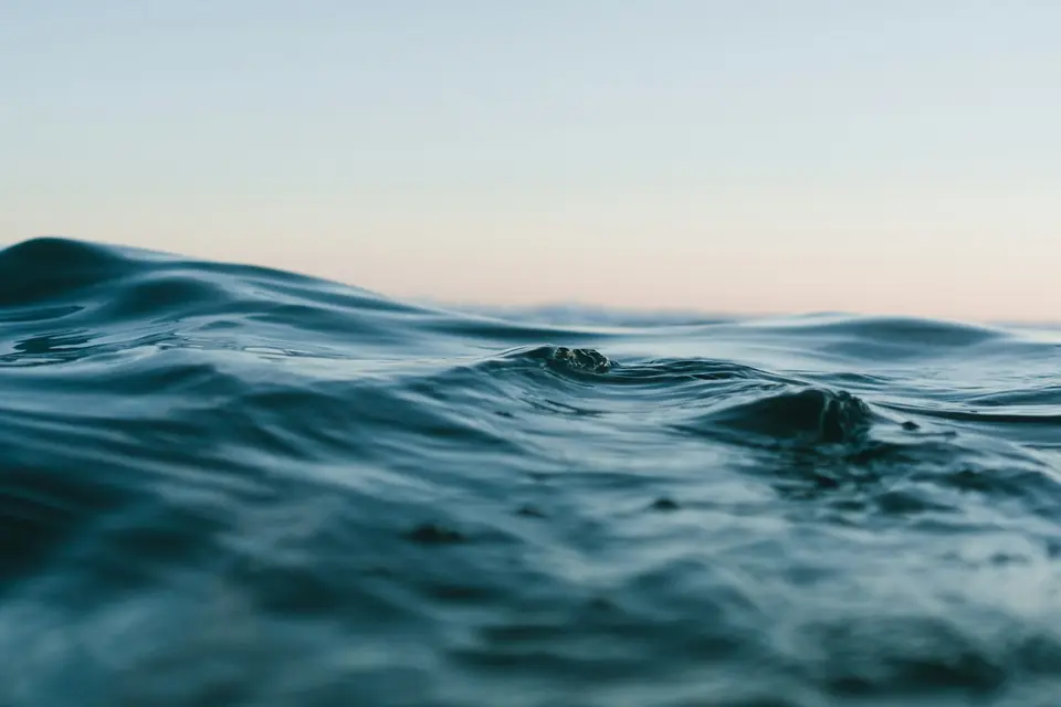 Soft rolling waves across a wide blue ocean